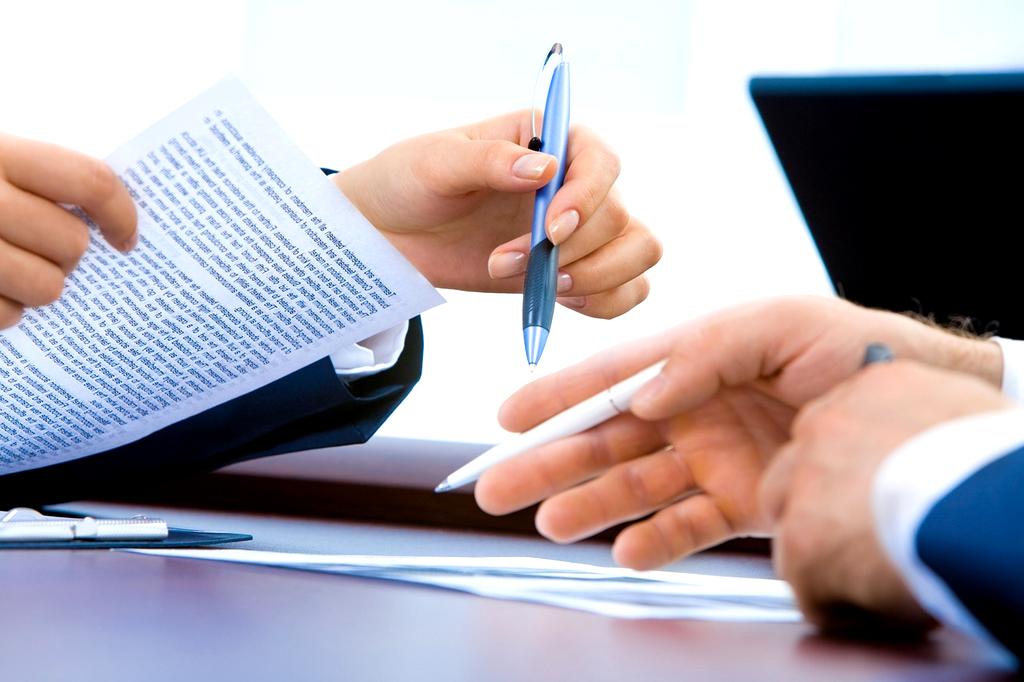 Ergonomic chair and desk with laptop in bright workspace